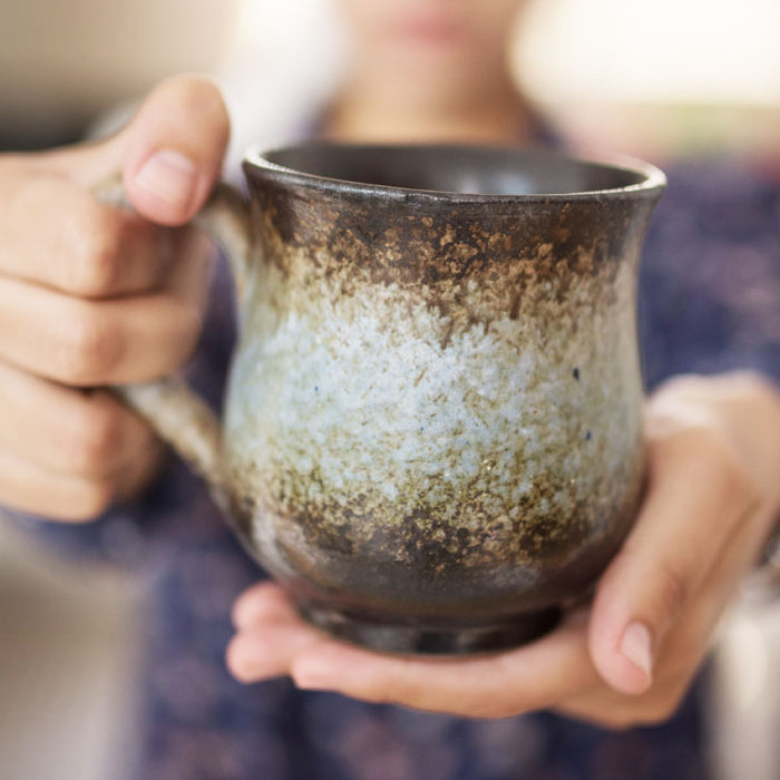 A Woman Holding a Ceramic Mug