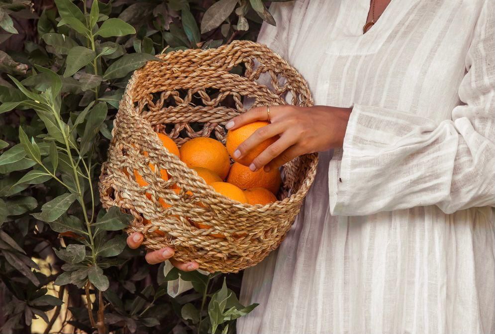 Woman Holding a Halfa Basket