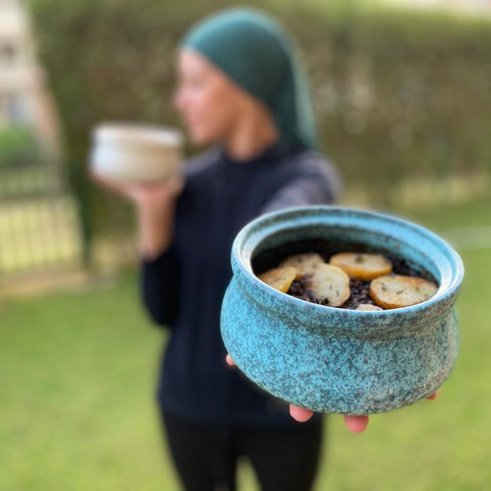 Ohoud Holding a Handmade Ceramic Pot