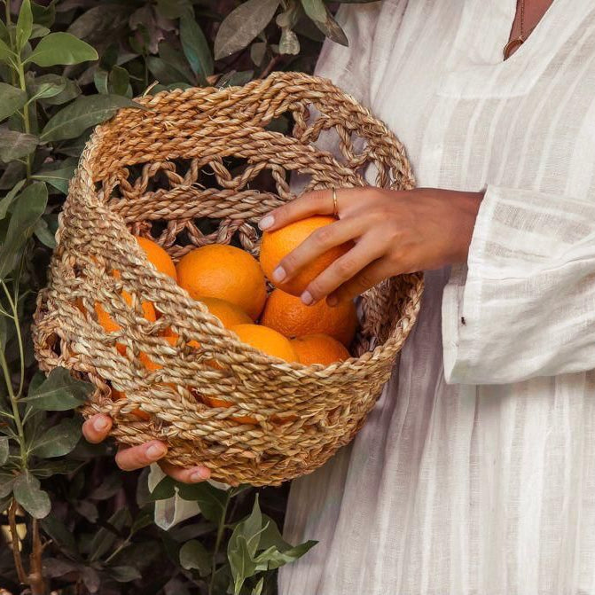 Woman Holding a Halfa Basket